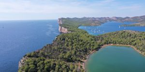 Stunning aerial view of Telascica Nature Park's coastline and lush forests in Croatia.