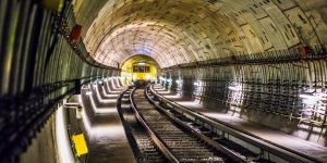 Dramatic view of a Berlin subway tunnel with train approaching, showcasing modern infrastructure.